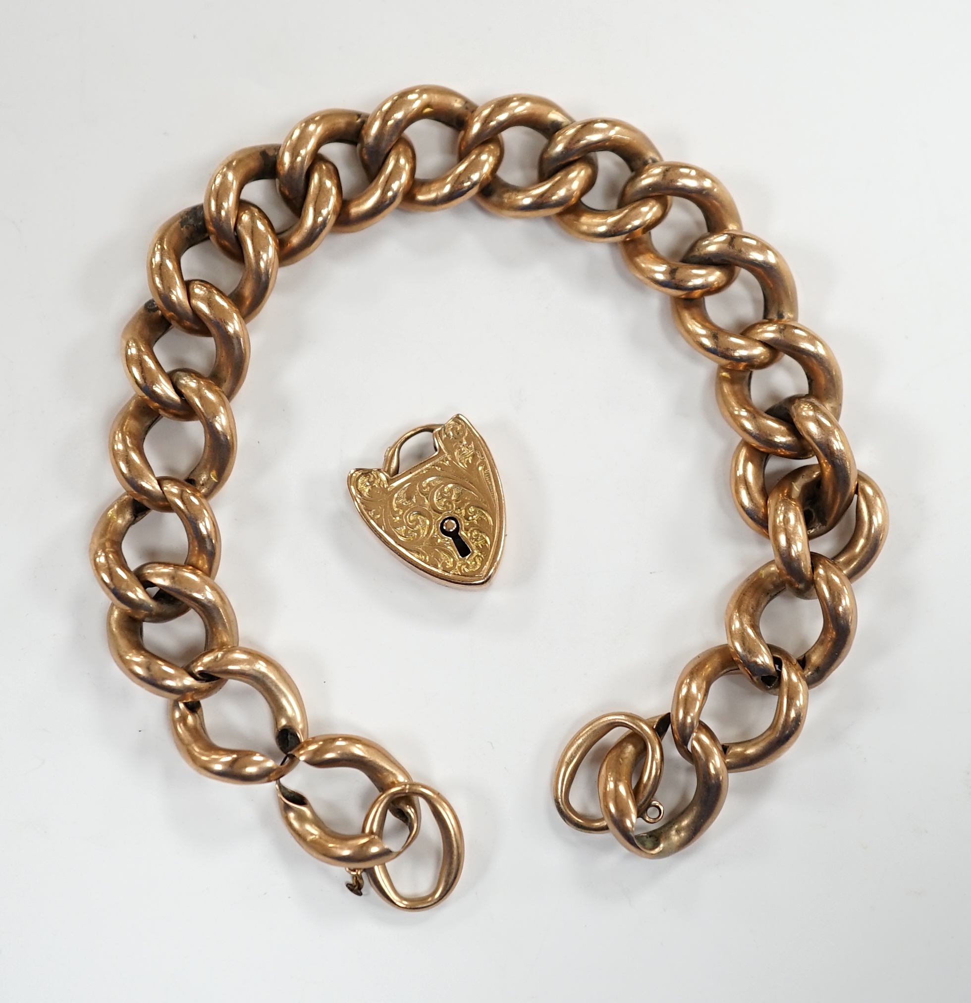 An Edwardian 9ct gold hollow curb link bracelet, with heart shaped padlock clasp(a.f.), 20cm